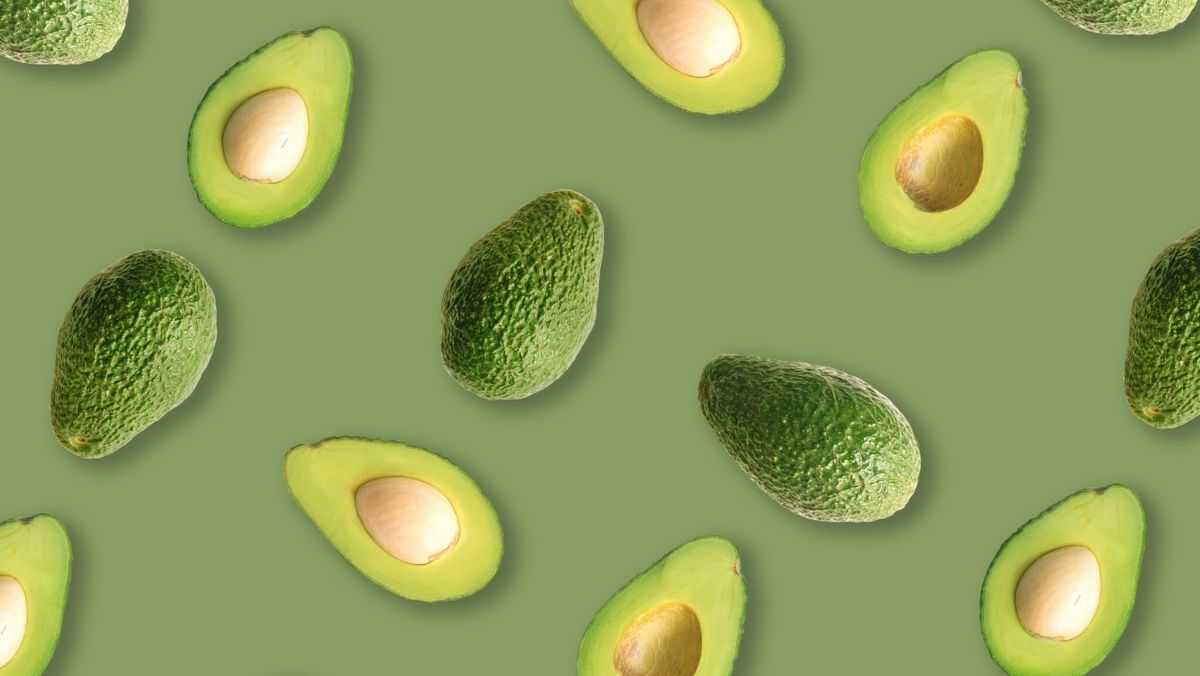 sliced avocadoes on green background