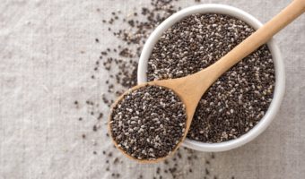 Plant-Based Sources of Omega-3-chia seeds in a wooden spoon and bowl