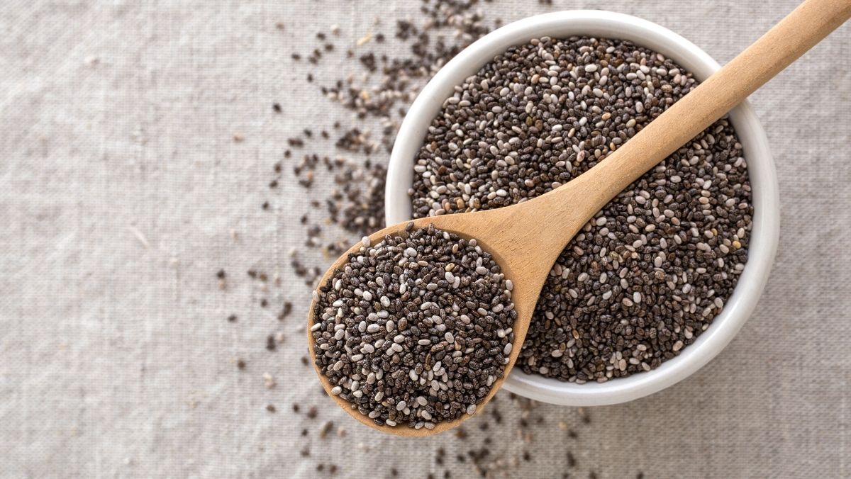Plant-Based Sources of Omega-3-chia seeds in a wooden spoon and bowl